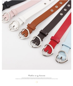 Detail of seven colored thin belts with heart-shaped metal buckles in high-quality finish