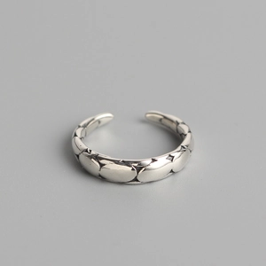 Minimalist S925 sterling silver open ring with irregular faceted texture on grey background