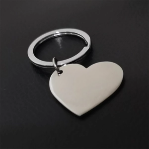 Polished heart-shaped stainless steel keychain for DIY engraving on black background