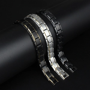 Detailed view of titanium steel magnetic therapy bracelets in black, gold, and silver