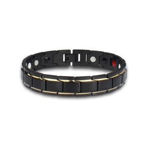 Detail view of black titanium magnetic bracelet with gold accents and therapy magnets