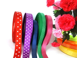 Polka dot grosgrain ribbons in various colors with pink carnation floral decoration