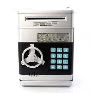 Detail of ATM savings bank keypad and cash slot on silver electronic safe for kids