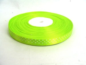 Detailed view of neon green polka dot grosgrain ribbon roll for DIY craft and gift wrapping