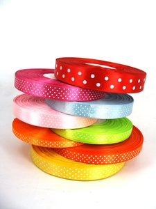 Detailed stack of colorful polka dot ribbons in various colors for DIY gift wrapping