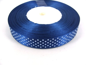 Macro view of navy blue grosgrain ribbon with white polka dots for DIY gift bows