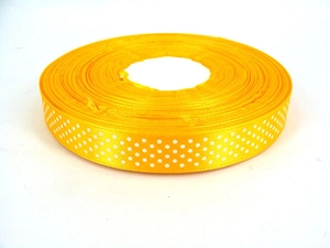 Detailed close-up of yellow grosgrain ribbon with white polka dots for gift wrapping