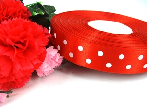 Detail of red grosgrain ribbon with white polka dots for gift boxes and DIY crafts