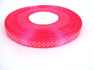 Close-up of hot pink grosgrain ribbon with white polka dots for DIY gift wrapping