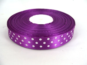 Detail of purple grosgrain ribbon with white polka dots in a compact roll format