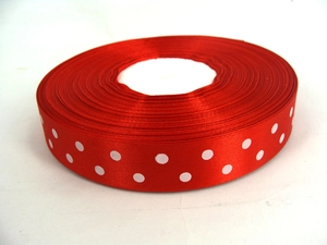 Close-up of red grosgrain ribbon with white polka dots for gift wrapping and DIY crafts