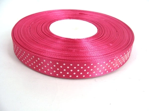 Close-up of rose red grosgrain ribbon with white polka dots for DIY gift wrapping and bows