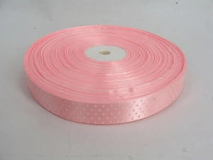 Detailed view of pink polyester grosgrain ribbon with white polka dots for DIY hair bows