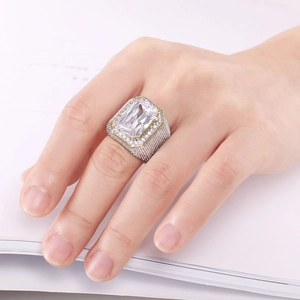 Close-up of iced out hip hop ring with large square zircon and gold plated detailing