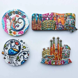 Detail view of four Barcelona mosaic resin fridge magnets on a white background