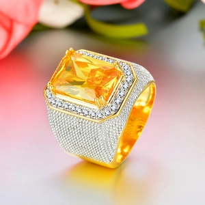 Macro shot of hip hop style square yellow zircon ring with iced out micro pavé setting