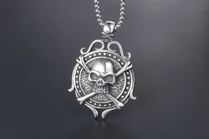 Detailed macro shot of vintage silver skull and crossbones punk pendant for men