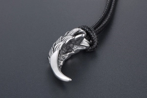 Macro shot of retro dragon scale tooth pendant with textured stainless steel finish