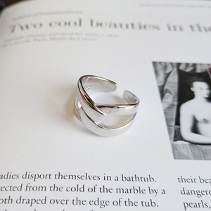 Macro shot of S925 sterling silver hallmark on modern crisscross knot open ring