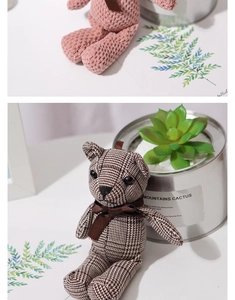 Detail of pink knitted and brown checkered teddy bear plush charms with satin ribbons