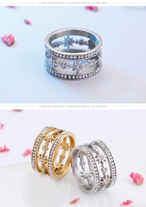 Detail of star-cutout stainless steel rings with zircon-studded bands in gold and silver