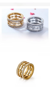 Detail of multi-layer star zircon ring in gold and silver finish with 12mm band width