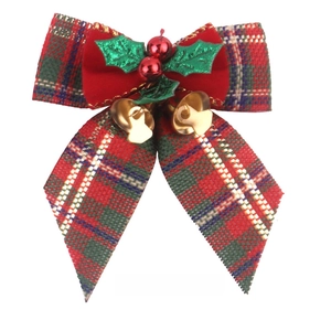 Close-up of a Christmas bow with red plaid fabric, holly leaves, and gold bells