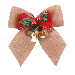 Detail of Christmas burlap bow with red velvet center, green leaves and gold bells