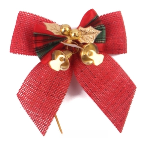 Detail of red mesh Christmas bow with gold bells, leaves, and plaid ribbon accent
