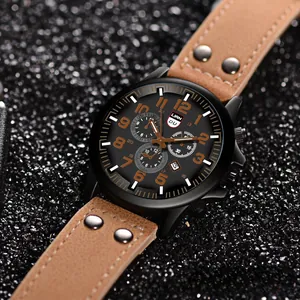 Close-up of men's matte black military watch with brown leather strap and orange numerals