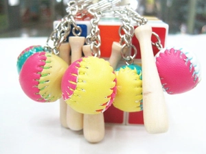 Close-up of mini baseball bat keychains with colorful leather balls and wooden pendants