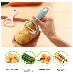 Detail of ergonomic ceramic peeler showing sharp blade removing skin from vegetables