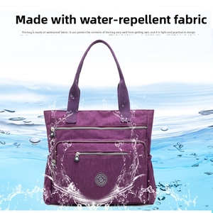 Waterproof purple nylon tote bag detail with multiple zippers and spacious side pockets