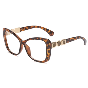 Cat eye tortoiseshell glasses frame with golden metal geometric accents on temples