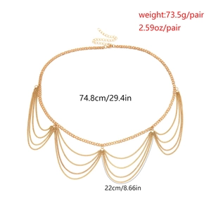Detailed view of layered gold chain body jewelry featuring wave fringe and lobster clasp