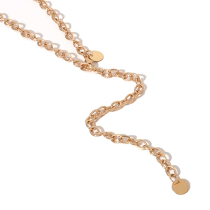 Detail of layered gold chain belt featuring oval links and smooth round coin charms