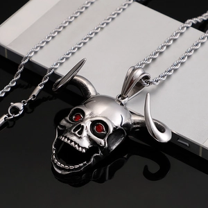 Silver horn skull pendant necklace with red gemstone eyes on a sleek twist chain