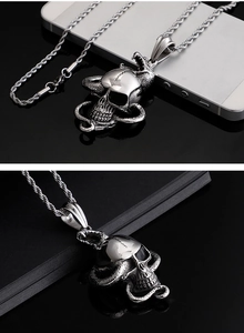 Macro view of punk style silver snake and skull pendant with strong metallic luster
