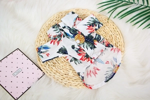 Detail of tropical Hawaiian pet shirt featuring vibrant floral patterns and white buttons