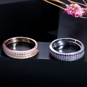 Elegant gold plated eternity rings with AAA zircons in various colors on dark display