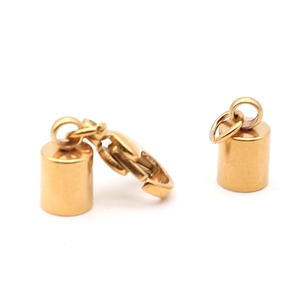 Detail of golden cylinder end caps with lobster clasp for jewelry DIY projects