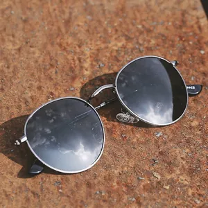 Retro round metal polarized sunglasses with silver textured frame and dark gray lenses