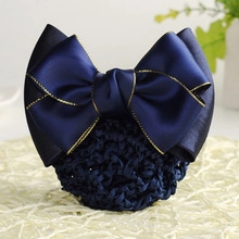 Detail of navy blue satin bow hairnet with gold trim for professional bun styling