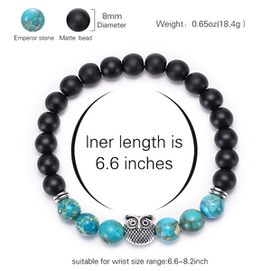 Beaded bracelet with black matte stones, blue king stone and silver owl charm detail