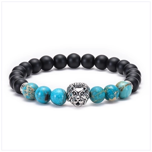 Detail of beaded bracelet featuring matte black stones, blue imperial jasper, and a silver lion head