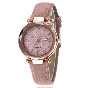 Detail view of a pink minimalist quartz watch with leather strap and classic dial