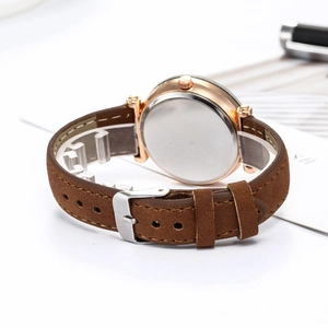 Detail view of the brown leather watch strap with silver buckle and polished round case