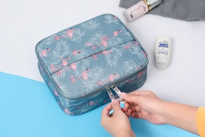 Waterproof cosmetic bag with flamingo pattern showing the zipper opening and handle