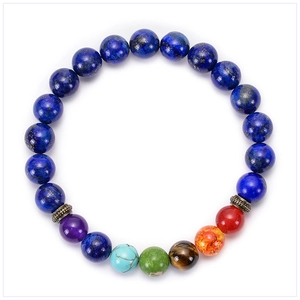 Detailed macro of 7 chakra natural stone yoga bracelet with lava beads and bronze spacers