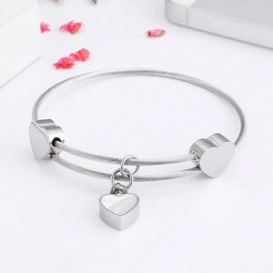 Polished silver heart bracelet set with steel wire weave design and heart charms